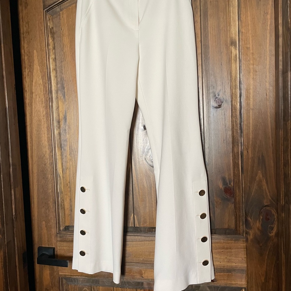 Trina Turk Size 6 white dress slacks with gold buttons accent on trouser bottom.